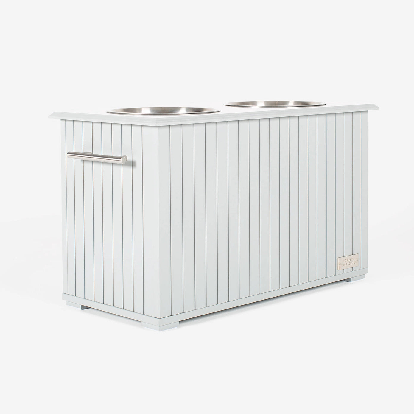 Station alimentaire blanche avec deux bols en acier inoxydable, conçue pour stocker et servir la nourriture et l’eau de manière hygiénique.